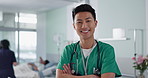 Face, happy nurse and Asian man with arms crossed in hospital for healthcare, wellness and medicine. Portrait, smile and confident medical worker, professional surgeon and expert employee in clinic