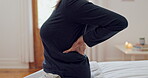 Senior woman, hands and back pain in home, bedroom or person in apartment with muscle, injury or osteoporosis. Mature, lady and health problem from arthritis, agony or medical crisis in house