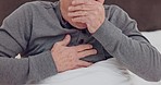 Senior man coughing with chest infection, allergies or sickness in bed in retirement home. Medical, recovery and closeup of elderly male patient resting with cold or sickness in his modern house.