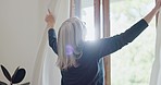 Back, window and curtain with a senior woman in the bedroom of her home in the morning during retirement. Summer, light and an elderly person looking through glass at the view from her apartment