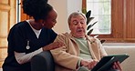 Tablet, nurse and senior man on sofa browsing on internet for medical consultation research. Bonding, healthcare and black woman caregiver talking to elderly patient networking on technology at home.