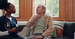 Healthcare, tablet and a senior man with a caregiver during a home visit for medical checkup in retirement. Technology, medicine and appointment with a nurse talking to an elderly patient on the sofa