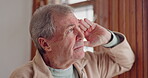 Depression, sad or nostalgia with a senior man looking through a window in his home during retirement. Thinking, memory or the past with an elderly person feeling lonely in the living room of a house