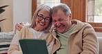 Tablet, laugh and senior couple on a sofa watching a funny, comic or comedy video on social media. Happy, smile and elderly people in retirement scroll on mobile app or internet on digital technology