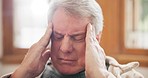 Home, depression and senior man with a headache, sick and health issue in a living room. Elderly guy, apartment and pensioner with stress, migraine or frustrated with inflammation, burnout or fatigue