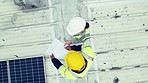 Engineer, safety and planning for solar with top view of installation, teamwork and blueprints for design on roof. Construction worker, electrician and maintenance for power of building with panel
