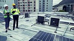 Teamwork, drone and solar engineers on roof, planning and people outdoor in city. Technician, photovoltaic panels and collaboration on rooftop for discussion on tablet, blueprint or renewable energy