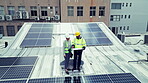 Construction, team or aerial view with solar panel on building for construction, design and inspection. Photovoltaic, people or planning or blueprint with discussion, conversation or talking outdoor