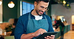 Cafe, man and business owner on tablet for restaurant sales, online management or customer service reviews. Happy entrepreneur, waiter or barista typing on digital technology for coffee shop startup