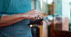 Hands, tablet and a waiter in a cafe for an online order as a small business owner or entrepreneur. Technology, ecommerce and retail with a restaurant worker closeup in a startup coffee shop