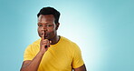 Secret, finger to lips and black man with privacy, confidential information and shush on blue background. Mockup space, quiet and silence gesture with emoji, gossip or whisper with news in studio