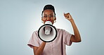 Face, protest or black woman shouting in studio on blue background for freedom on megaphone. Change, news announcement or African person screaming with loudspeaker for human rights speech or justice 