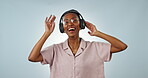 Singing, dance or black woman listening to music, podcast or radio audio on subscription in studio. Eyes closed, headphones or happy girl streaming a song isolated on a white background for wellness 
