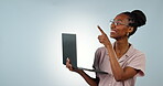 Laptop, pointing or happy black woman in studio for social media mockup space or copywriting research. Ecommerce, face or African person typing online for promo news or sale on a white background 