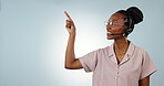 Customer support, studio and happy black woman point at telemarketing news, call center promo or help desk direction. Contact us, mockup space portrait and sales agent advertising on blue background