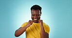 Black man, dancing with energy and celebration, happiness and fun in studio with music on blue background. Dancer, party and techno with achievement or winning, mockup space and smile in studio