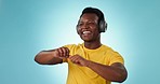 Happy black man, headphones and dancing to music, podcast or playlist against a studio or blue background. African male person smile and enjoying audio streaming, songs or sound track on mockup
