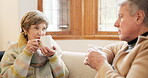 Talking, senior couple and relax in home with coffee, drink or conversation in morning together in retirement. Old people, speaking and drinking tea, espresso or cappuccino on sofa in living room