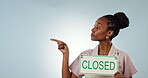 Economy, financial crisis and closed sign with a black woman on space in studio on a gray background. Portrait, bankruptcy and coffee shop closing with young person pointing to small business mockup
