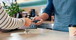 Customer, barista and pos machine with credit card for payment, transaction or checkout at cafe. Closeup of person, hands and paying with debit for coffee, tea or beverage at restaurant or cafeteria