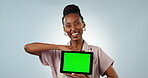 Business owner, face or green screen on a tablet in studio for social media, advertising or online branding. Blue background, happy black woman or waitress showing app chroma key or mockup space 