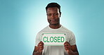 Business owner, closed sign and face of black man on a blue background for communication. Shaking head, sad and portrait of an African person or entrepreneur with a poster for no service on backdrop