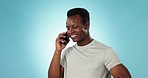 Man, conversation and smile for phone call in studio by blue background for communication, hello and chat. Happy black person, smartphone and texting on technology, laughing and talk to connect