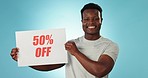 Happy black man, billboard and discount for promotion on sale in advertising or marketing against a studio background. Portrait of African male person with sign in retail, special deal or store promo