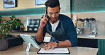 Cafe, phone call of waiter and man on checklist, talk or conversation. Coffee shop, tablet and happy barista on smartphone for discussion, reading document and customer service at table in restaurant