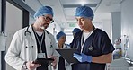 Teamwork, talking and doctors with a tablet at a hospital for health advice or surgery communication. Help, clinic and medical employees speaking with technology, planning and schedule for nursing