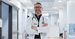 Professional, face and man or doctor with arms crossed for wellness, trust and service in hospital or clinic. Portrait, person and expert with happiness for career, cardiology or glasses at workplace