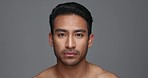 Face, cosmetics and Asian man with beauty, skincare and dermatology on a grey studio background. Portrait, Japanese person and model with wellness, luxury treatment and spa grooming with aesthetic