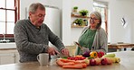 Old couple in kitchen, cooking together with discussion and help, support or planning recipe with vegetable. Healthy food, senior man and woman in home with conversation for meal prep, diet and lunch