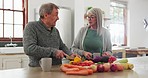 Old couple in kitchen, cooking together with conversation and help, support or planning recipe with vegetable. Healthy food, senior man and woman in home with discussion for meal prep, diet and lunch