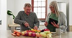 Old couple in kitchen, cooking with tablet and help, online recipe for vegetables and conversation. Healthy food, senior man and woman in home with digital app on meal prep, diet and lunch discussion