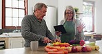 Old couple at kitchen counter, cooking together with tablet and help with online recipe for vegetables. Healthy food, senior man and woman in home with digital app for meal prep, diet and lunch ideas