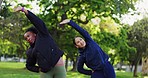 Interracial women, fitness and stretching in nature for body workout, exercise or training together. Female person, friends or personal trainer in warm up stretch or coaching at park for wellness