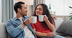 Asian couple, coffee and cheers or drink with smile for relax, morning espresso or breakfast with satisfied face. Love, people or happiness with mug for energy, romance or break on couch in lounge