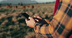 Farmer, phone and cows on field for agriculture, eco friendly and sustainability business with free range animals. Person hands, seller or supplier typing on mobile for e commerce, cattle and farming