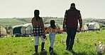 Farmer, family and girl walk in field with parents in countryside, nature or holding hands together. Sustainable, agriculture and farming chicken, poultry or livestock on grass with greenhouse