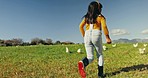 Running, back and a child on a farm for chicken growth, fun and playing in a field. Countryside, playful and a girl kid in nature with animals for agriculture, sustainability and freedom in ecology