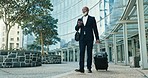 Phone, suitcase and businessman walking in city for corporate work trip flight by airport. Travel, luggage and professional African executive ceo networking on cellphone by building in urban town.