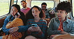 Phone, friends and travel in van on road trip, typing or reading on social media. Car, journey and serious group of people, men and women with kid sleeping on drive for vacation, holiday or adventure