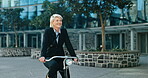 Businesswoman, happy and riding a bicycle to work, health and wellness. Mature person, smile and commute or transport to office, active and cardio in eco friendly, bike and carbon neutral footprint