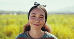 Happy, face and woman in spring, field or farm with flowers, daisies and nature in countryside. Person, smile and relax in portrait with calm, happiness or wellness in natural summer environment