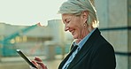 Phone, senior woman and ceo typing in city, lens flare and sunset outdoor. Mobile, scroll and happy business consultant in street reading email, social media and networking on app for communication