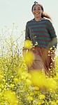 Happy woman, flower and field run closeup on adventure, travel and summer in countryside in grass. Vacation, walking and freedom on holiday with smile and nature with smile and sunshine on trip