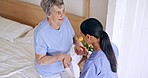 Old woman, bed or caregiver helping in nursing home, retirement clinic for wellness or support. People, nurse or elderly patient holding hands with doctor or social worker for injury rehabilitation 