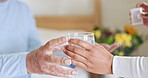 Hands, caregiver or senior patient with pills or supplements for healthcare vitamins or medicine in home. Water, medication tablets or nurse giving drugs for nursing or helping a sick senior person