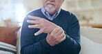 Hands, senior man and wrist with pain, injury and orthopedic wound at home. Closeup, elderly guy and stretching fingers for ache, arthritis and osteoporosis for muscle joint, carpal tunnel and health